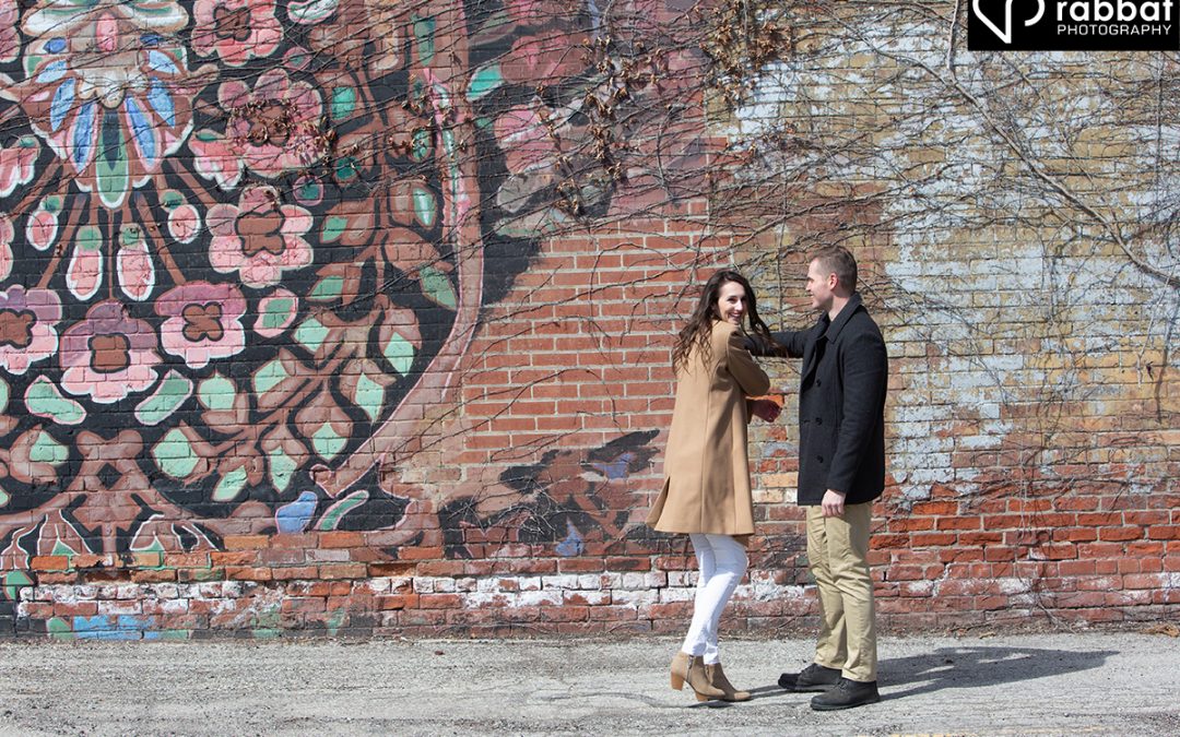 Dancing in front of mural for engagement photos