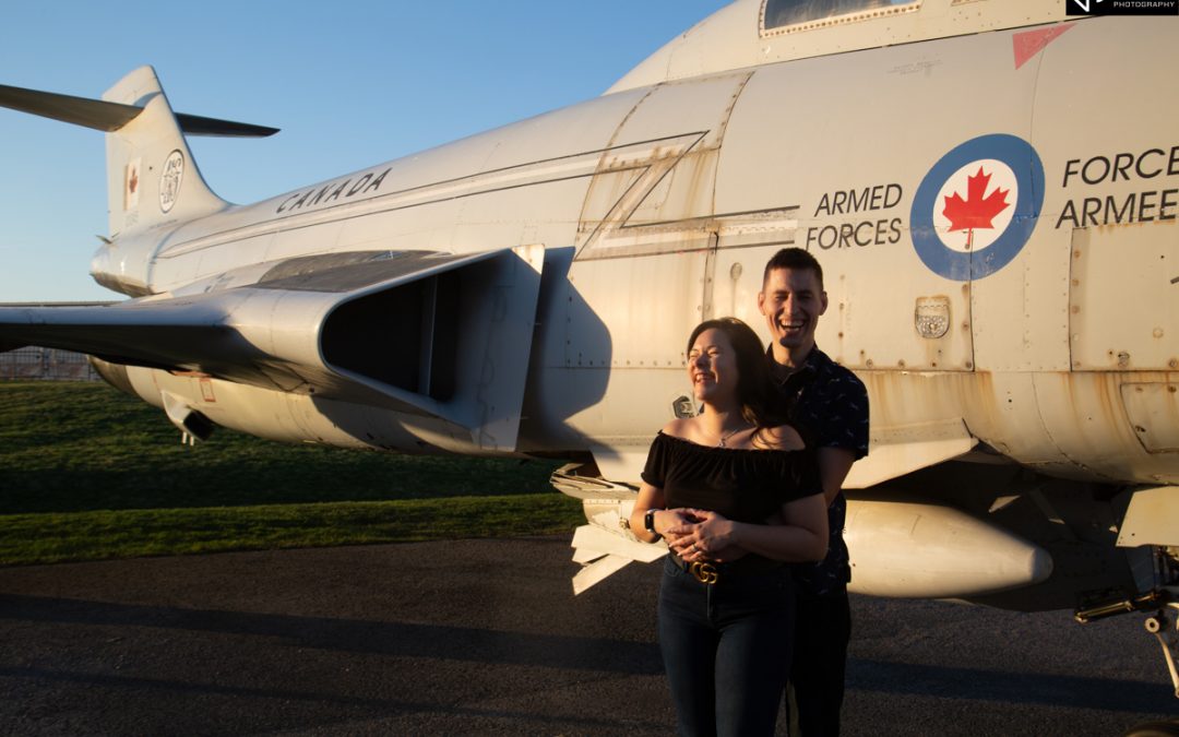 Couple laughing in front of Canadian Forces airplane